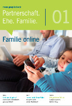 Kleines Kind tippt auf Smartphone, Papa daneben mit Laptop