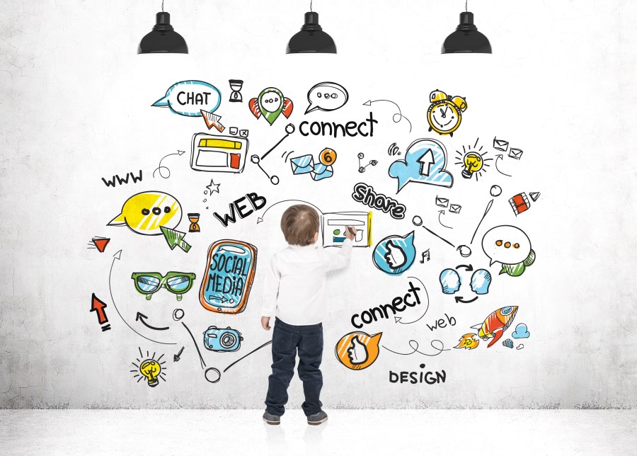Kind malt an Wand Worte und Bilder aus Mediensprache